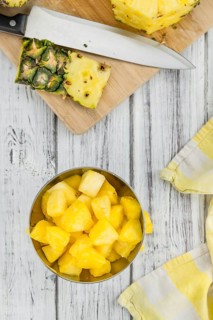 Sliced Pineapple on an old wooden table as detailed close-up shot, selective focus