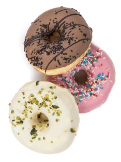 Some fresh made Donuts isolated on white background (close-up shot)