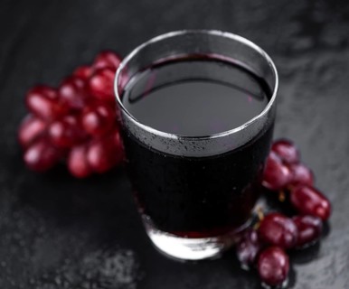 Some fresh Red Grape Juice (selective focus, close-up shot)