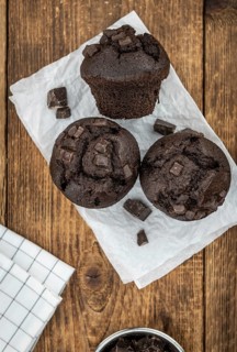 Some fresh Chocolate Muffins (selective focus, close-up shot)