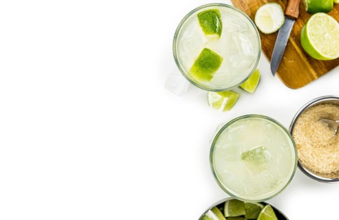 Caipirinha isolated on white background (selective focus, close-up shot)
