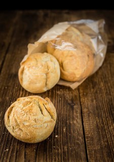 Fresh made German Buns on an old and rustic wooden table, selective focus, close-up shot