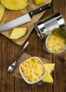 Preserved Pineapple pieces on a vintage background as detailed close-up shot, selective focus