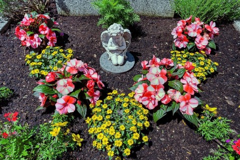 Grave with floral decoration and cherub, Allgäu, Swabia, Bavaria, Germany, Europe
