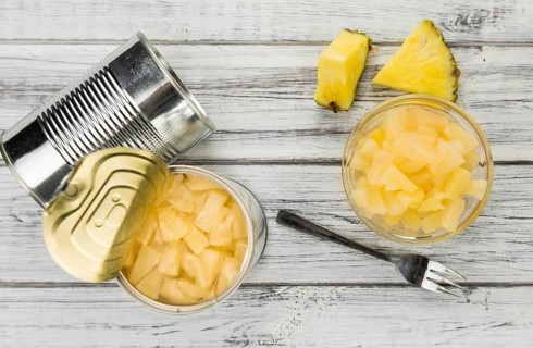 Preserved Pineapple pieces on a vintage background as detailed close-up shot, selective focus
