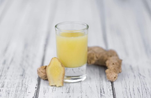 Portion of fresh Ginger Juice (selective focus, close-up shot)