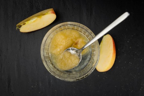 Slate slab with homemade Applesauce (close-up shot, selective focus)