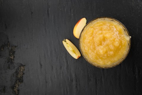 Portion of homemade Applesauce (selective focus, close-up shot) on vintage background