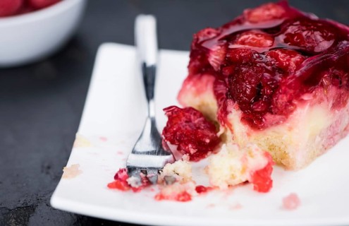 Fresh made Raspberry Cake on a rustic slate slab (close-up shot, selective focus)