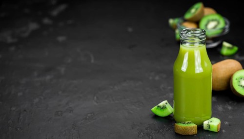 Kiwi Smoothie (selective focus) on an old and vintage background (homemade)