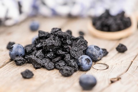 Fresh made Dried Blueberries on a vintage background as detailed close-up shot