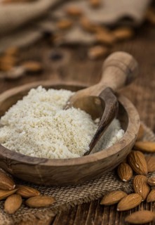 Portion of fresh Powdered Almonds on an old wooden table