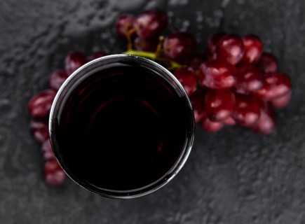 Fresh Red Grape Juice as detailed close-up shot (selective focus)