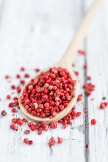 Portion of fresh Pink Peppercorns close-up shot, selective focus