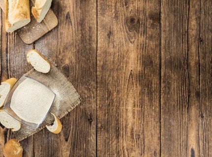 Some Bread Crumbs on a vintage wooden table (selective focus, close-up shot)