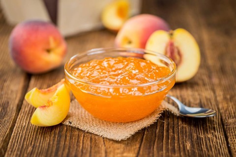 Peach Jam on a vintage background as detailed close-up shot, selective focus