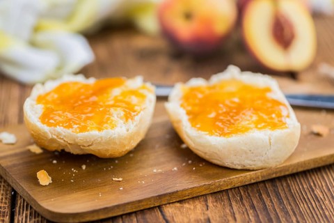 Portion of fresh Peach Jam close-up shot, selective focus