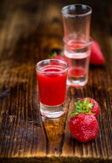Homemade Strawberry liqueur on vintage background selective focus, close-up shot