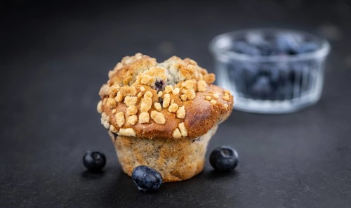 Portion of healthy Blueberry Muffins on a slate slab (selective focus)
