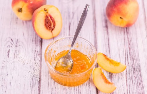 Portion of fresh Peach Jam close-up shot, selective focus