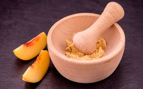 Peach powder on a vintage slate slab as detailed close-up shot, selective focus