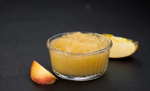 Slate slab with homemade Applesauce (close-up shot, selective focus)