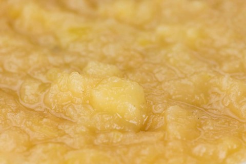 Homemade Applesauce (selective focus, close-up shot) on vintage background with some fresh fruits