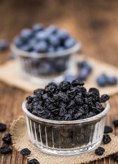 Fresh made Dried Blueberries on an old and rustic wooden table, selective focus, close-up shot