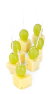 Cheese blocks with grapes isolated on white background (partyfood)