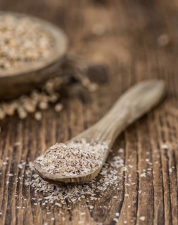 Wheat Bran on an old wooden table (selective focus)