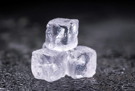 Some melting Ice cubes on a vintage slate slab (selective focus)