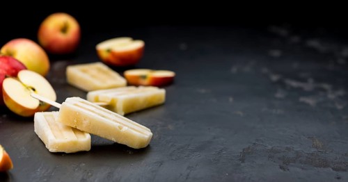 Fresh made Apple Popsicles (selective focus, close-up shot) on a vintage background