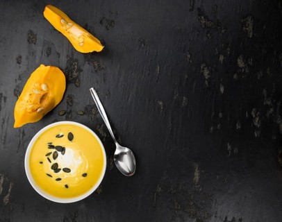Fresh made Pumpkin Soup (close-up shot) on a vintage background (selective focus)