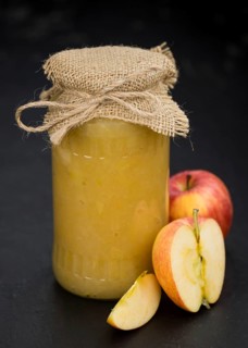 Portion of homemade Applesauce (selective focus, close-up shot) on vintage background