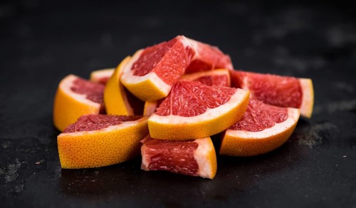 Grapefruits slices (selective focus) on a vintage background as detailed close-up shot
