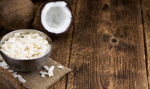 Coconut Chips (fresh) as detailed close-up shot, selective focus)