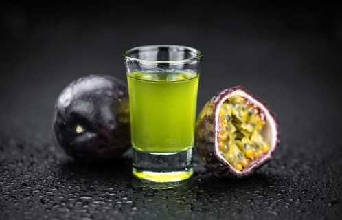 Passion Fruit Liqueur on a vintage looking slate slab (selective focus)