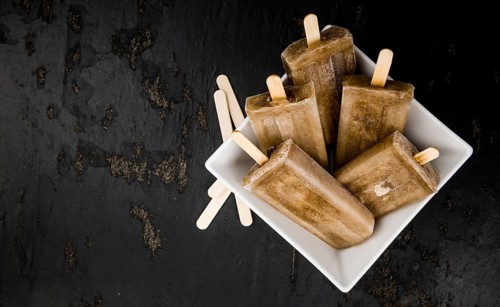 Slate slab with cola popsicles (homemade) as detailed close-up shot (selective focus)