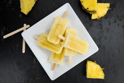 A rustic slate slab with homemade Popsicles (selective focus, close-up shot)