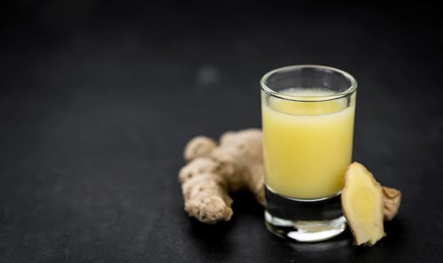 Portion of fresh Ginger Juice (selective focus, close-up shot)