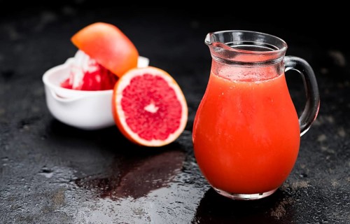 Slate slab with freshly squeezed Grapefruit Juice (selective focus, close-up shot)