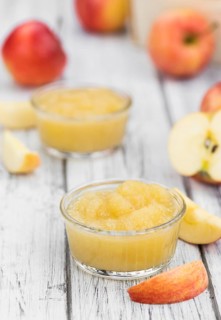 Old wooden table with fresh made Applesauce (selective focus, close-up shot)