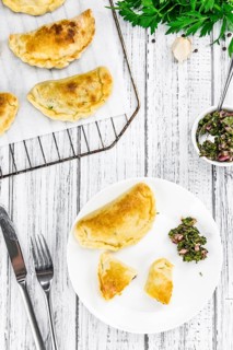 Portion of healthy Empanadas on an old wooden table (selective focus, close-up shot)