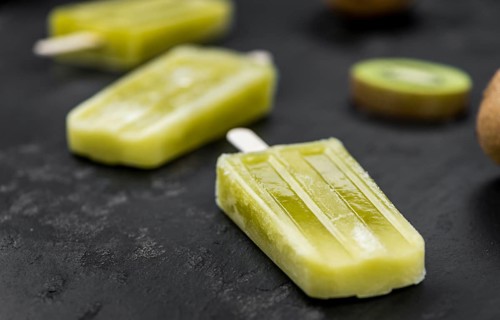 Kiwi Popsicles on a vintage looking slate slab (selective focus)