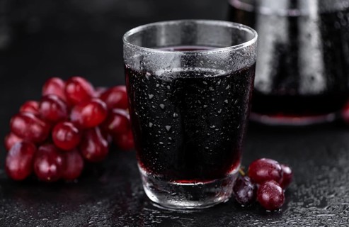 Some fresh Red Grape Juice (selective focus, close-up shot)
