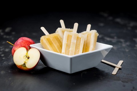 Fresh made Apple Popsicles (selective focus, close-up shot) on a vintage background