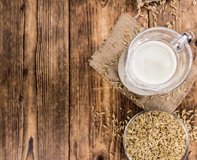 Wooden table with Oat Milk (detailed close-up shot, selective focus)