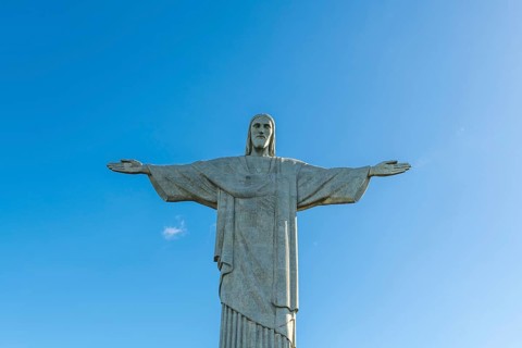 Christ the Redeemer statue in Rio de Janeiro, Brazil with blue sky in the background