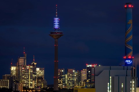 The top of the Europe Tower in Frankfurt am Main shines in the blue of the European Union (EU)