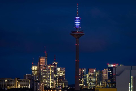 The top of the Europe Tower in Frankfurt am Main shines in the blue of the European Union (EU)